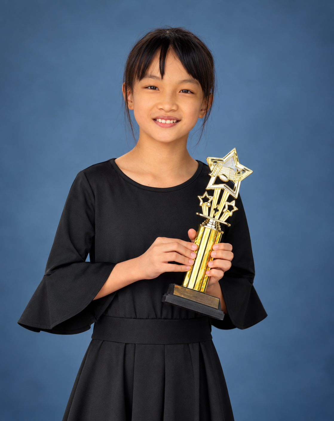 SBMC student holding a competition trophy