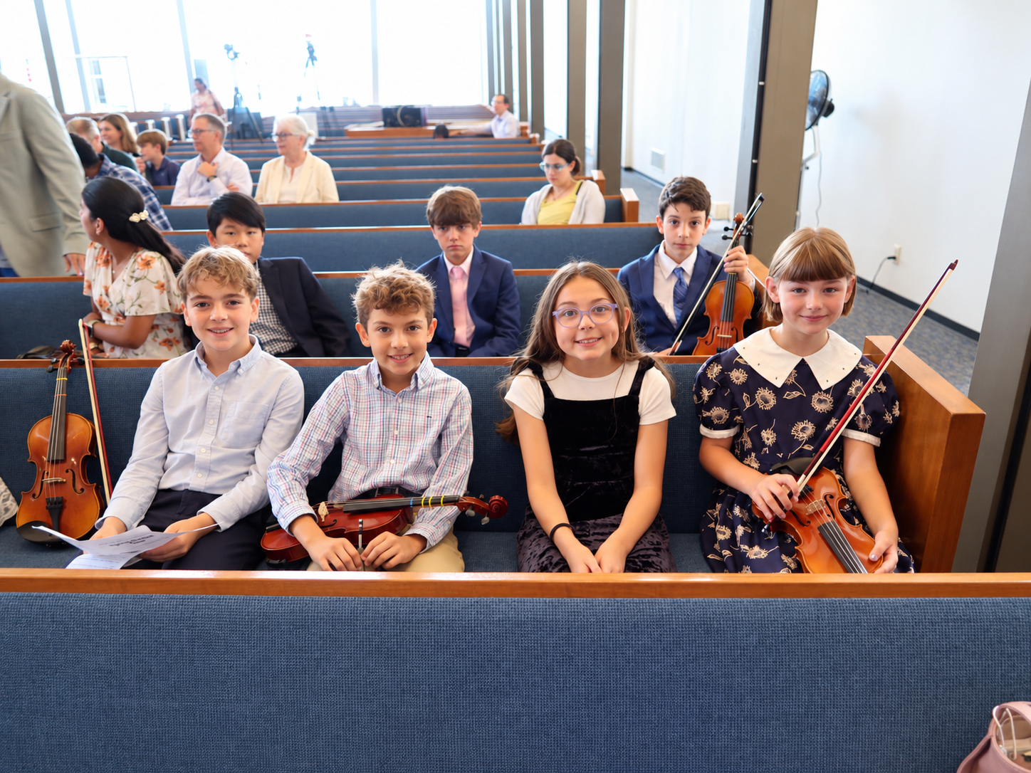 Students seated together with their violins
