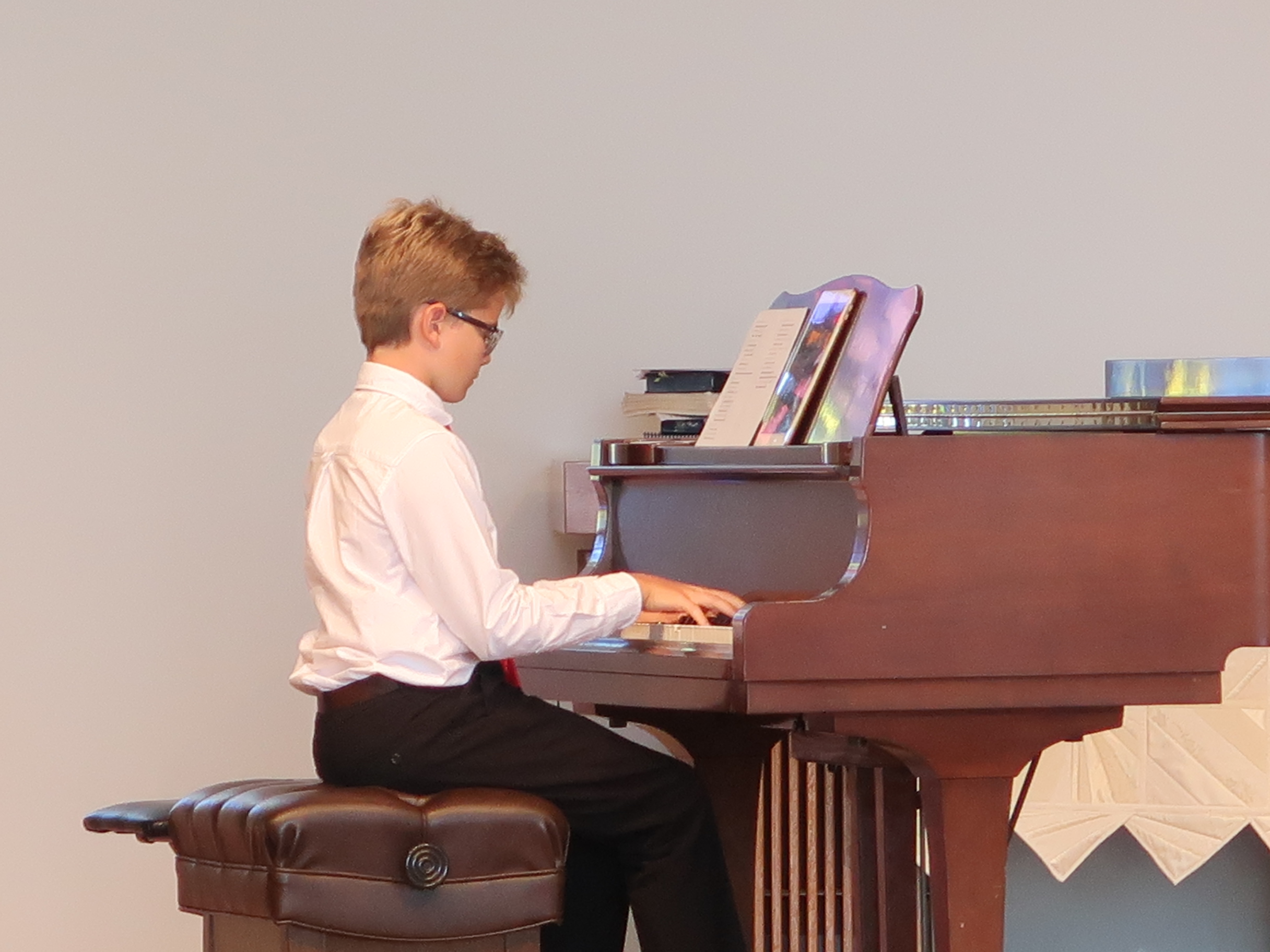 Student performing at the piano