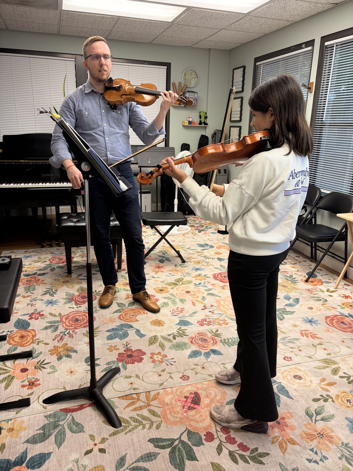 Teacher and student playing violin during a lesson