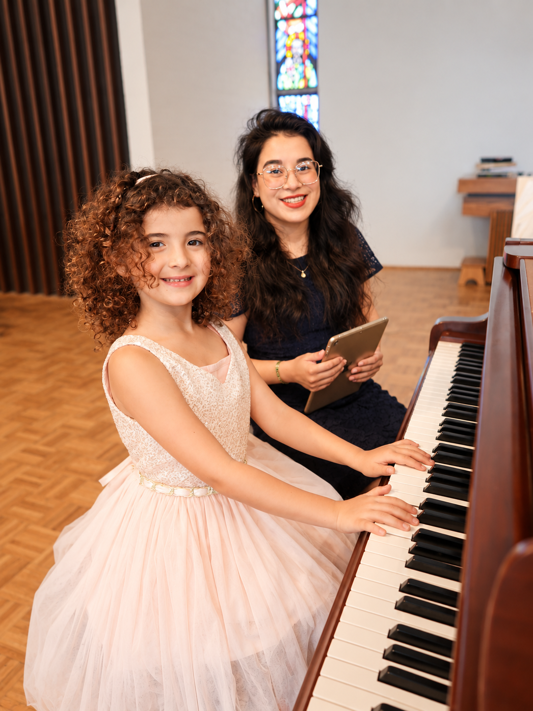 Student at the piano with an adult